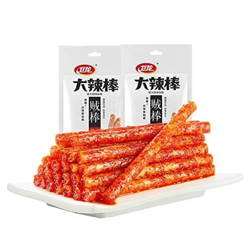 Chinese Spicy Latiao Gluten Strips stacked on a platter with packaging in the background.