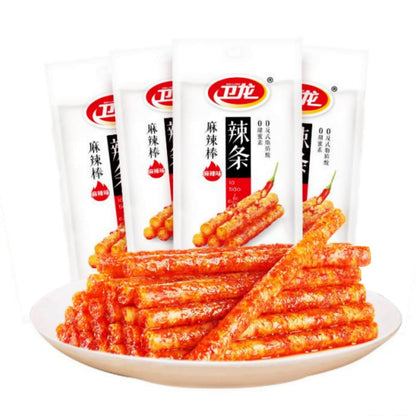 Chinese Spicy Latiao Gluten Strips displayed on a plate with packaging in the background.