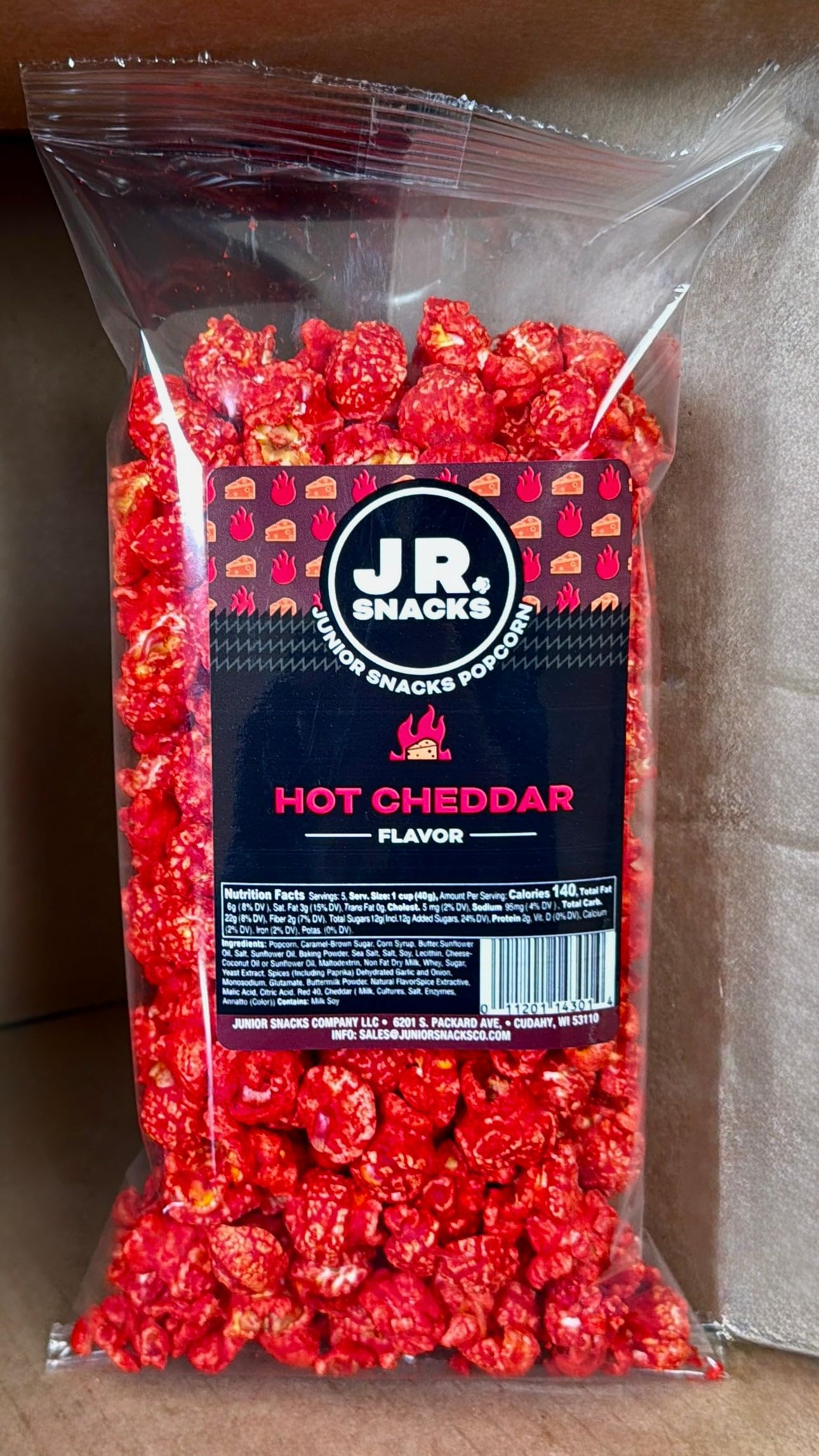 Hot Junior Snacks Co. Hot Cheddar bag filled with spicy cheddar popcorn for snack lovers.