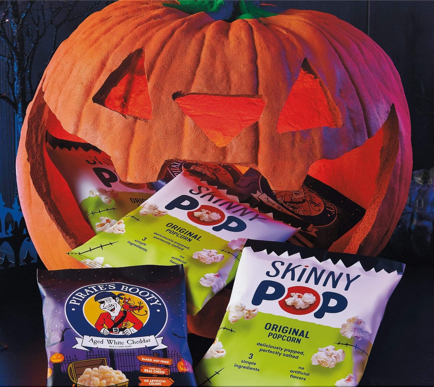 SkinnyPop Family Favorite Variety Pack featured in a Halloween-themed setup with a carved pumpkin.